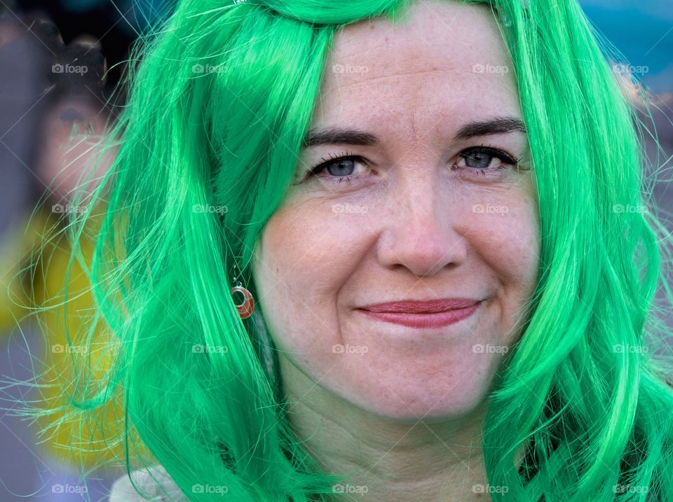 A participant in the New York City St. Patrick's Day Parade celebrating with green hair,
