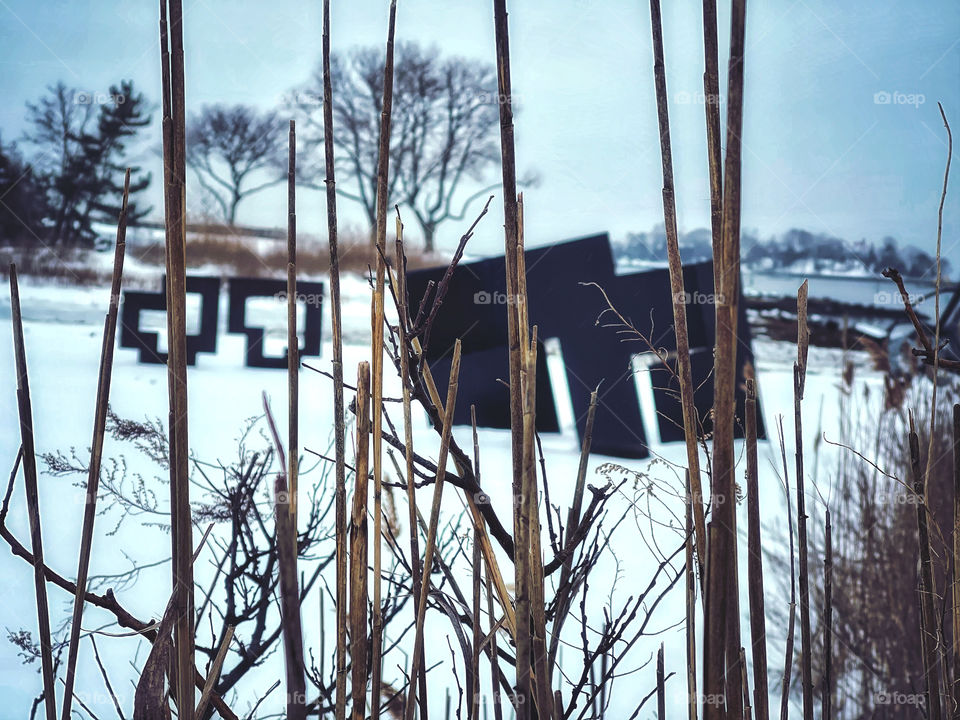 Statuary through grass and snow 