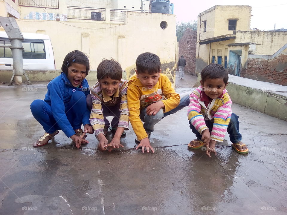 Children playing marbles.....
enjoying every moment.