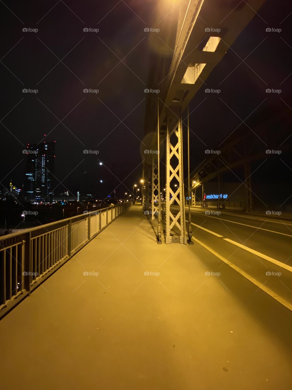 Way on a bridge at night with yellow lights