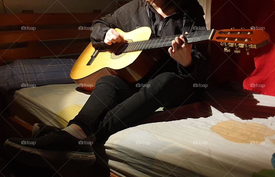 A moment in our personal space, playing the guitar, a very beautiful musical instrument and a spectacular sound