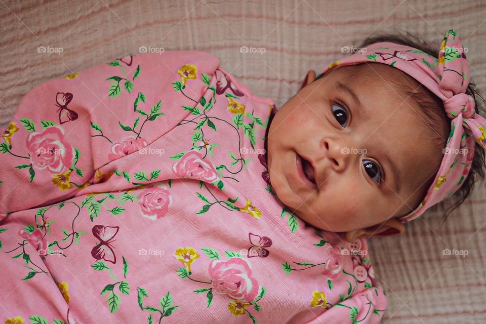 Cute baby girl showing expression of surprise, surprised baby girl, baby girl dressed in pink, baby with look of surprise on her face, surprised baby, looking down on baby, surprising babies 