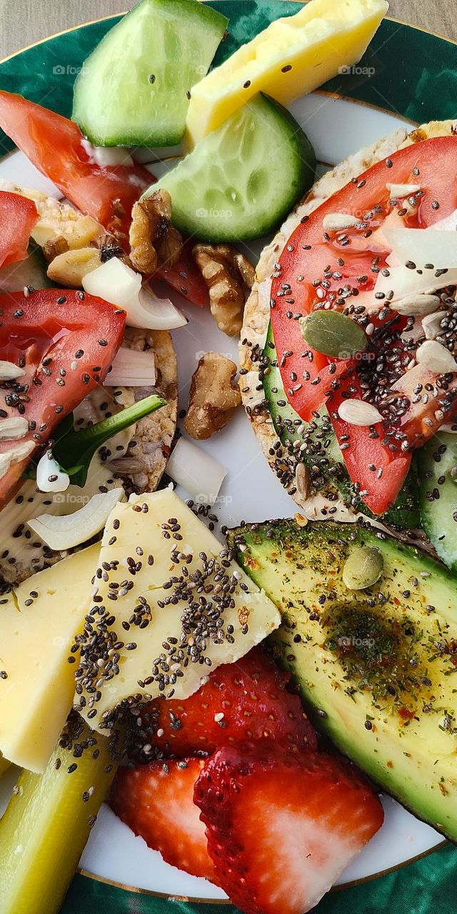 Closeup of healthy gourmet sandwich with tomato, cheese and avocado.