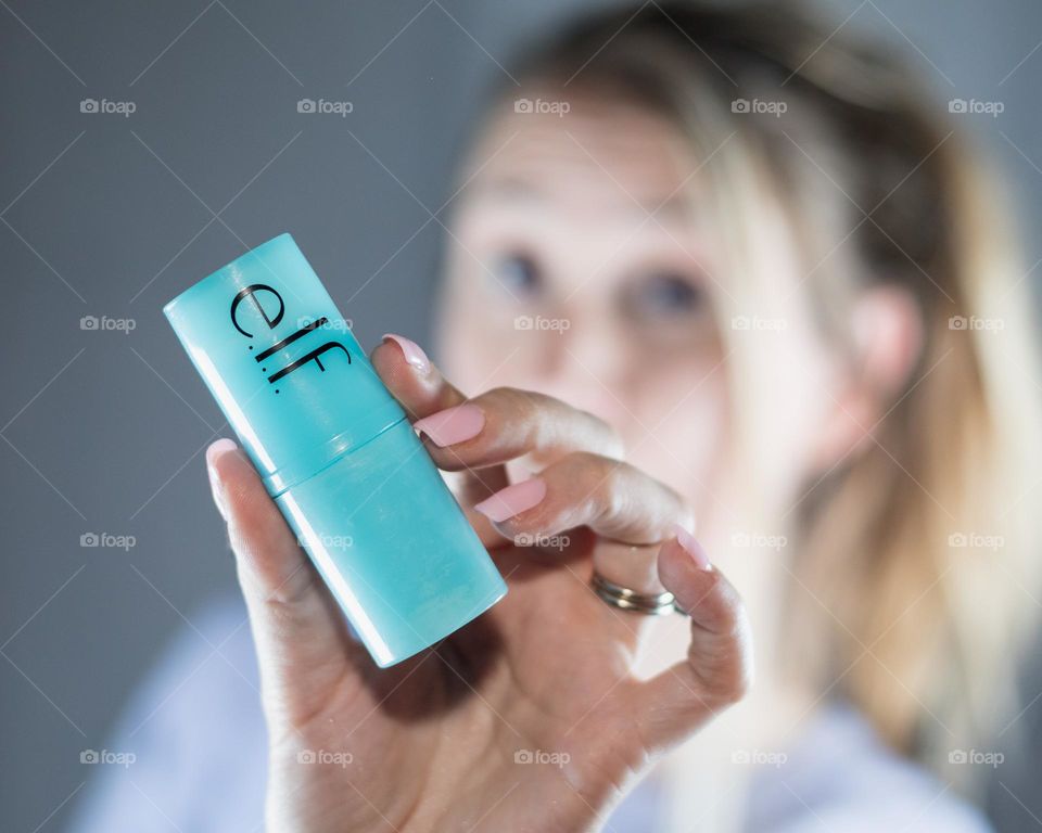 Holding a hydration skin stick close to the camera