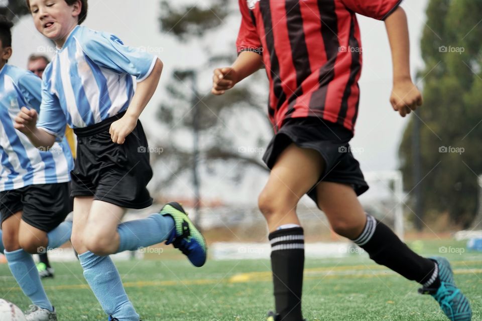 Kids Running In A Soccer Match