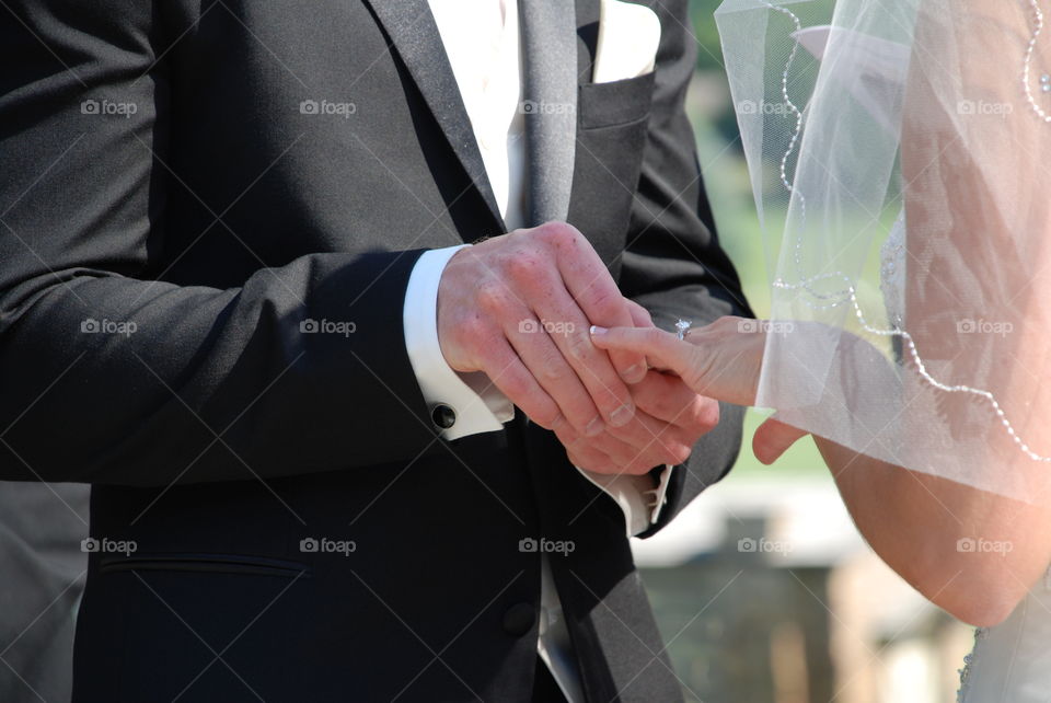 Photo of my son placing a ring on his soon to be wife's finger.