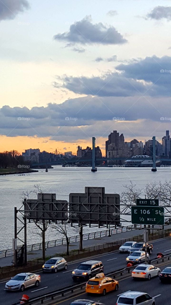 rush hour traffic by East River over look Randall's island and midtown and Queens