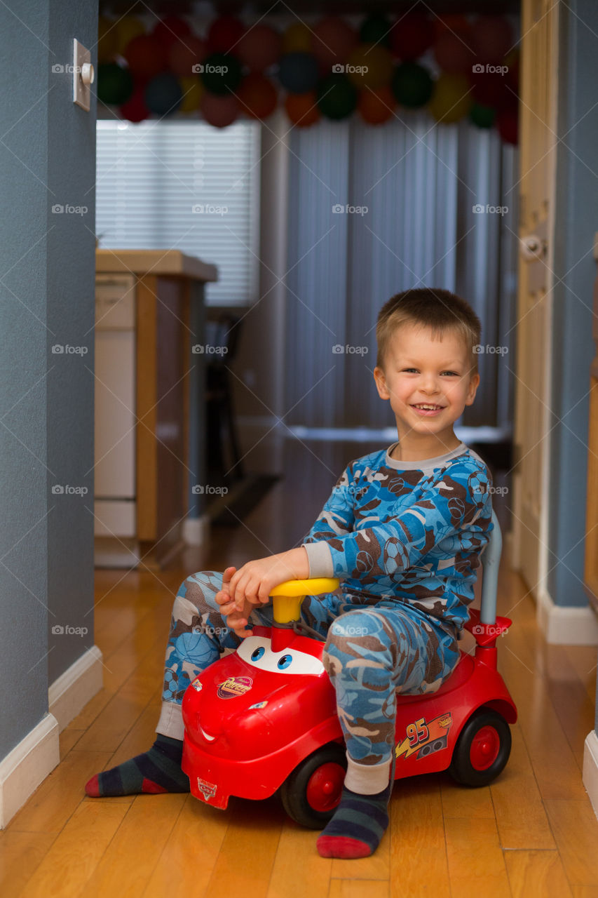 Toddler on plastic toy car