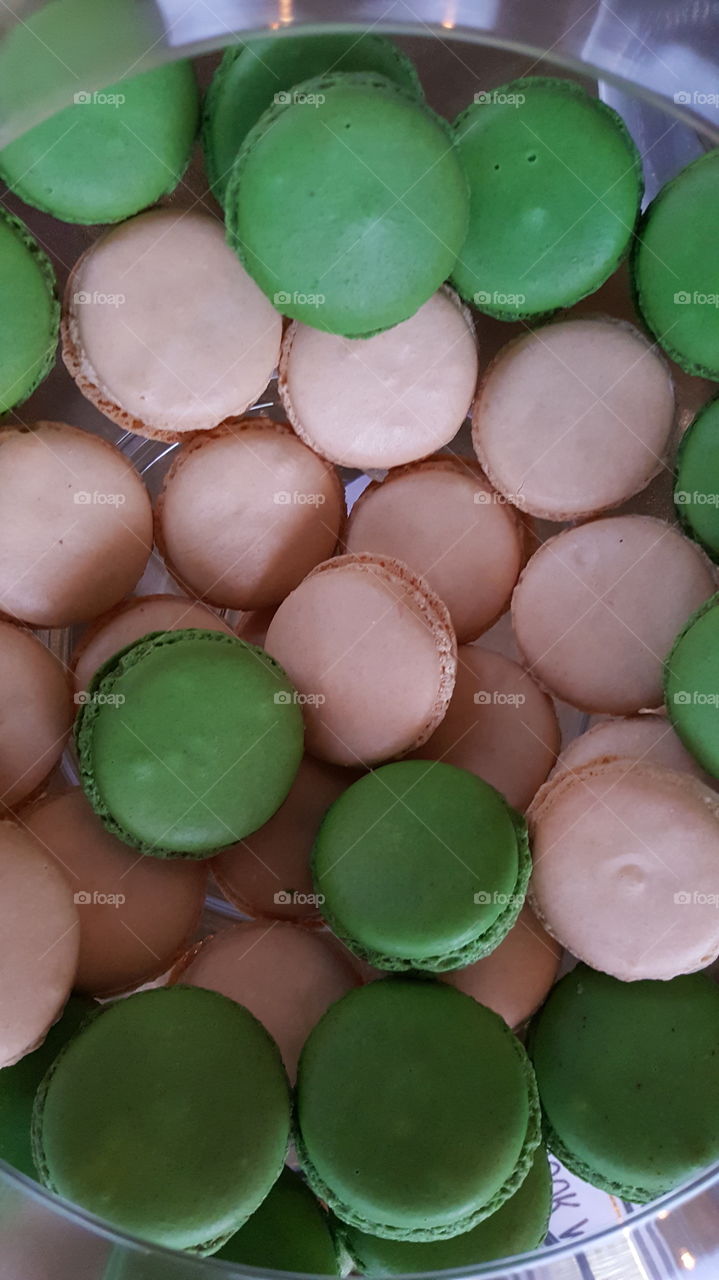 Lychee macarons on display. confectionery, desserts, pink and green macarons.
