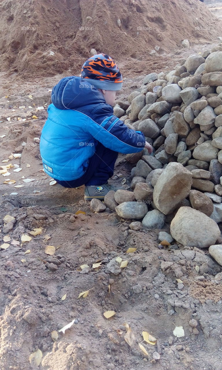 boy play with rocks