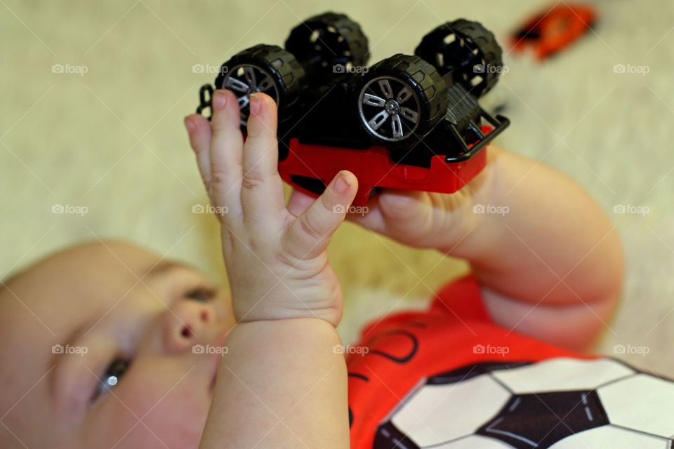 baby plays with a car