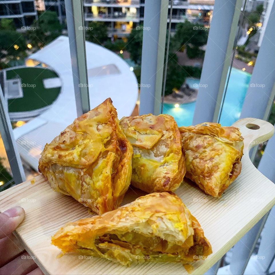 Chicken curry puff cut cross section laid in chill and relaxing setting 