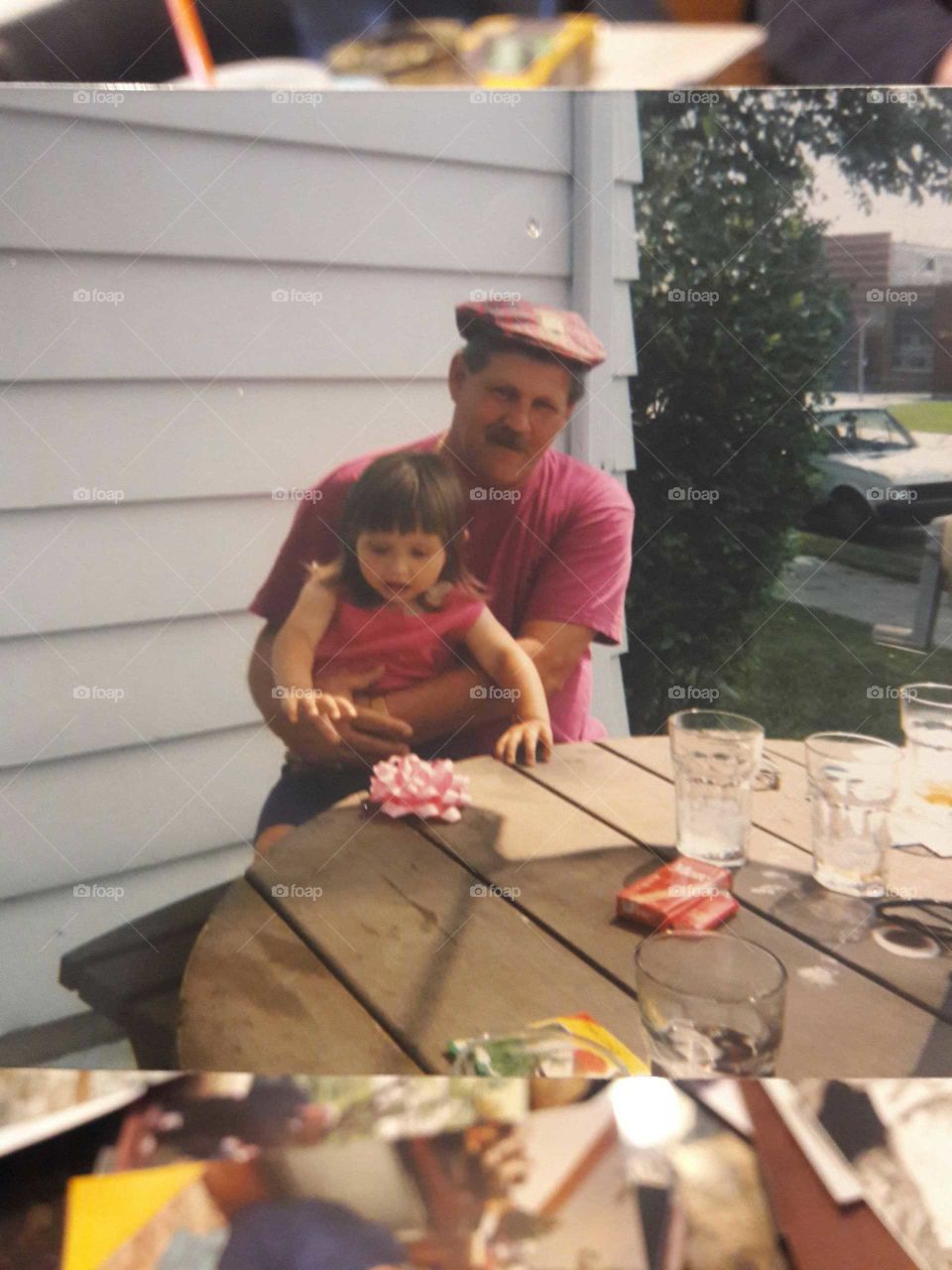 an old photo of me and my grandfather years ago, matching in pink outfits.
