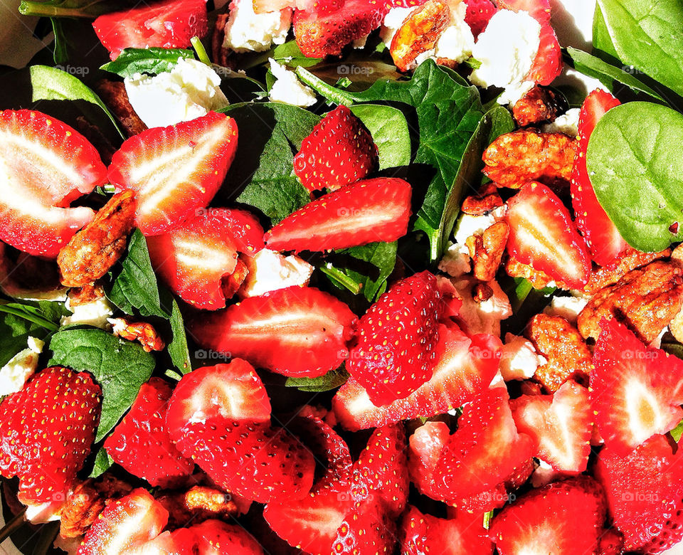 Fresh locally grown strawberries, spinach, and feta cheese in a