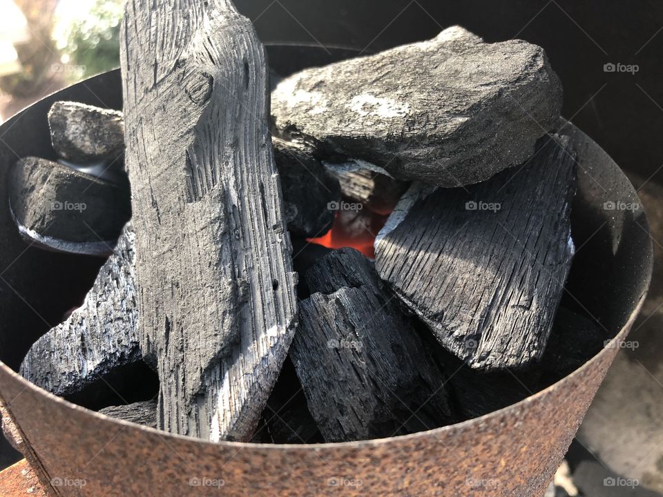 Bbq coals burning in chimney getting ready to grill