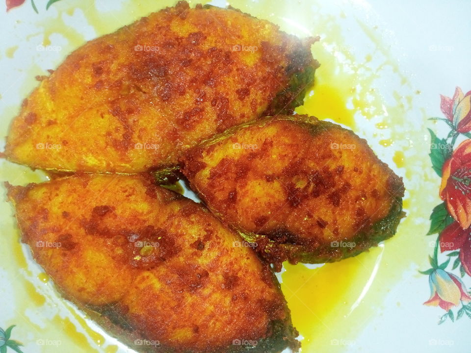 Three fried fish cuts on a plate