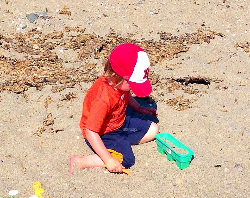 Playing in the sand . Water is too cold to swim in, so playing in the sand was in order