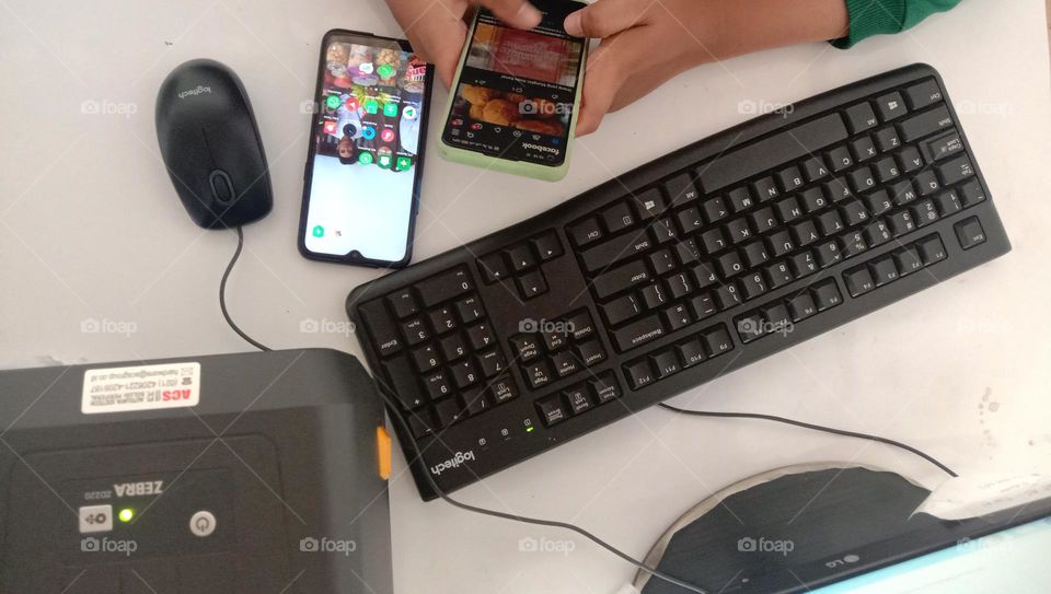 High angle view, person holding smartphone on work desk