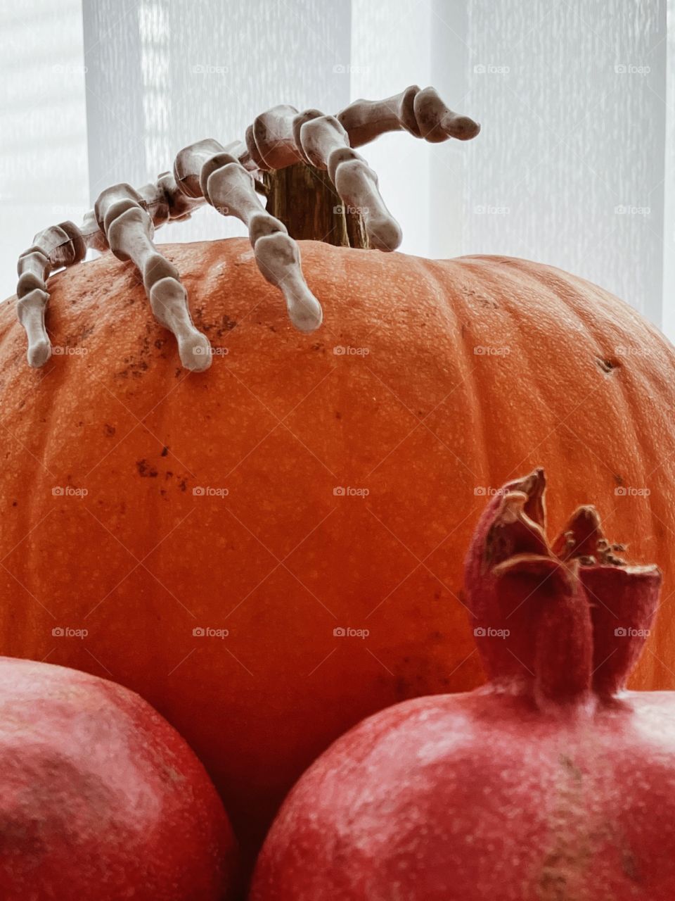 pumpkin with skeleton hand