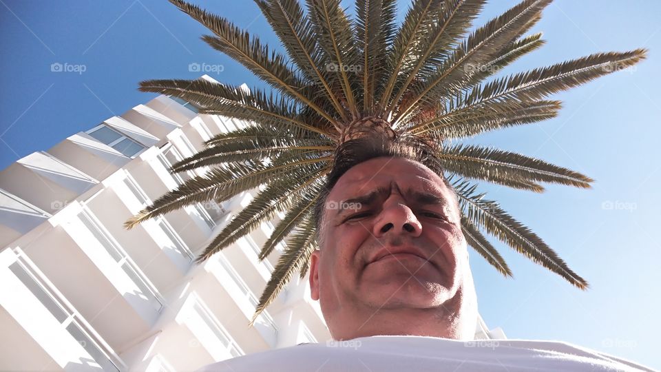 Senior man standing in front of building