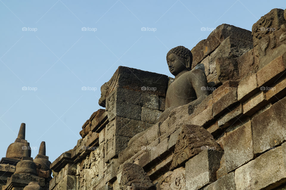 one of the statues of buddha in borobudur temple