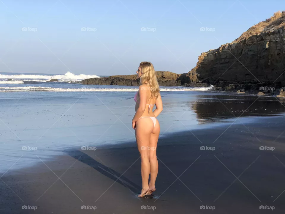 Early morning walk along private black sand beach in Costa Rica 