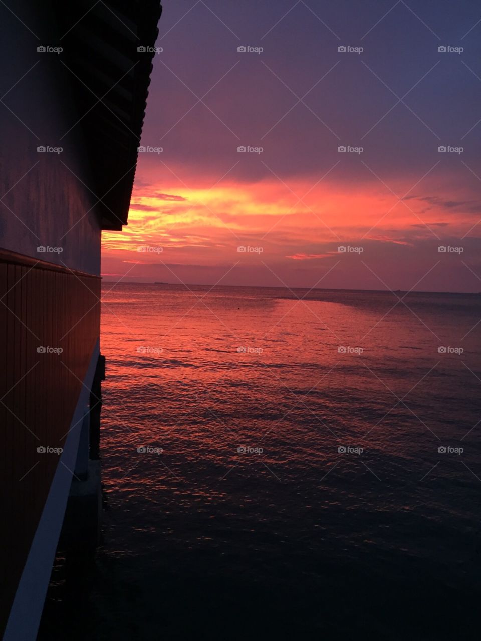 Sunset on the Malacca Straits. Now to take this photo I very nearly dropped my phone into the sea! Taken of the side of the chalet I was staying in. 