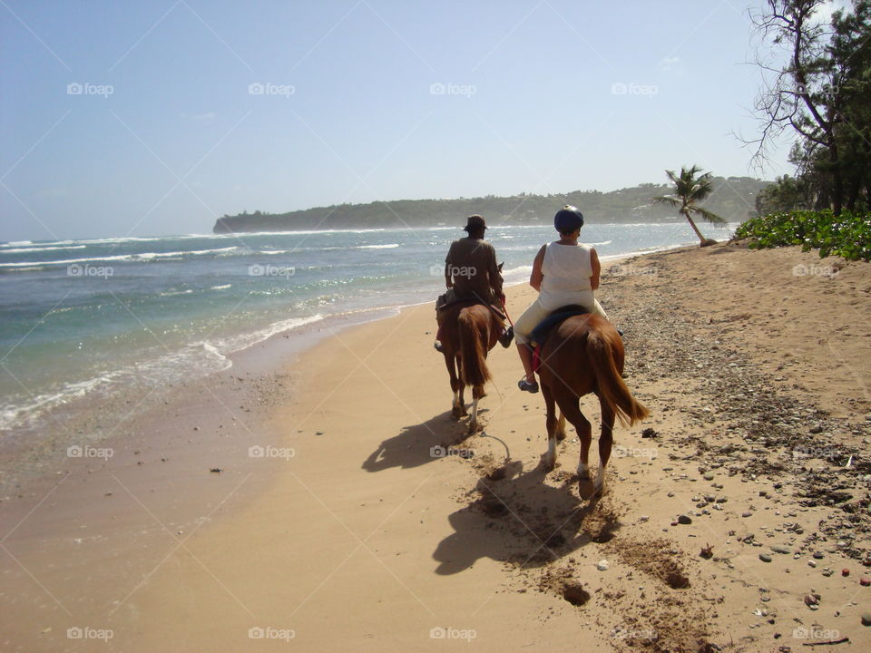 Riding horses on the beach