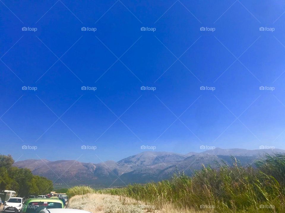 Deep blue skies with rolling hills behind 