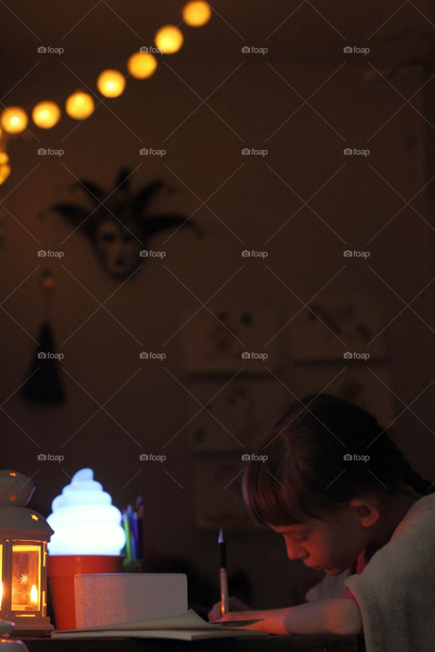 Little girl prepares for the holiday and writes a letter to Santa Claus