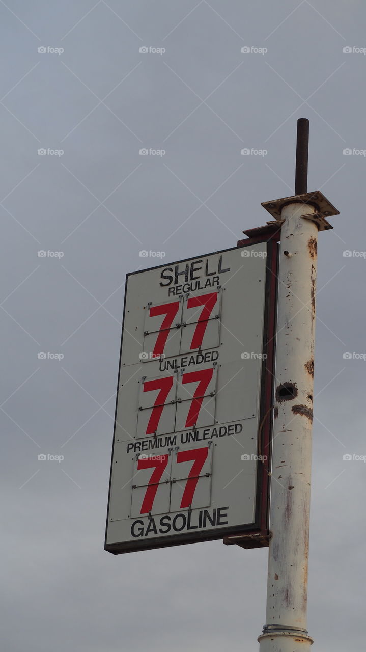 Forgotten old gas station sign. Price tag sign gas station regular unleaded fuel americana