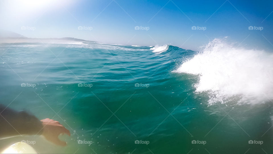 Surfing a Clean and Small Wave During a Sunny and Hot Morning