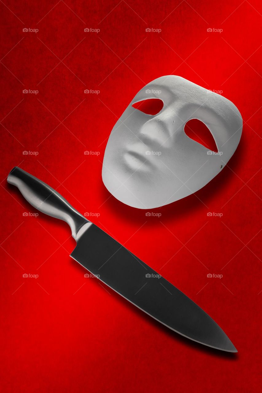 A knife and a white Mask on are background