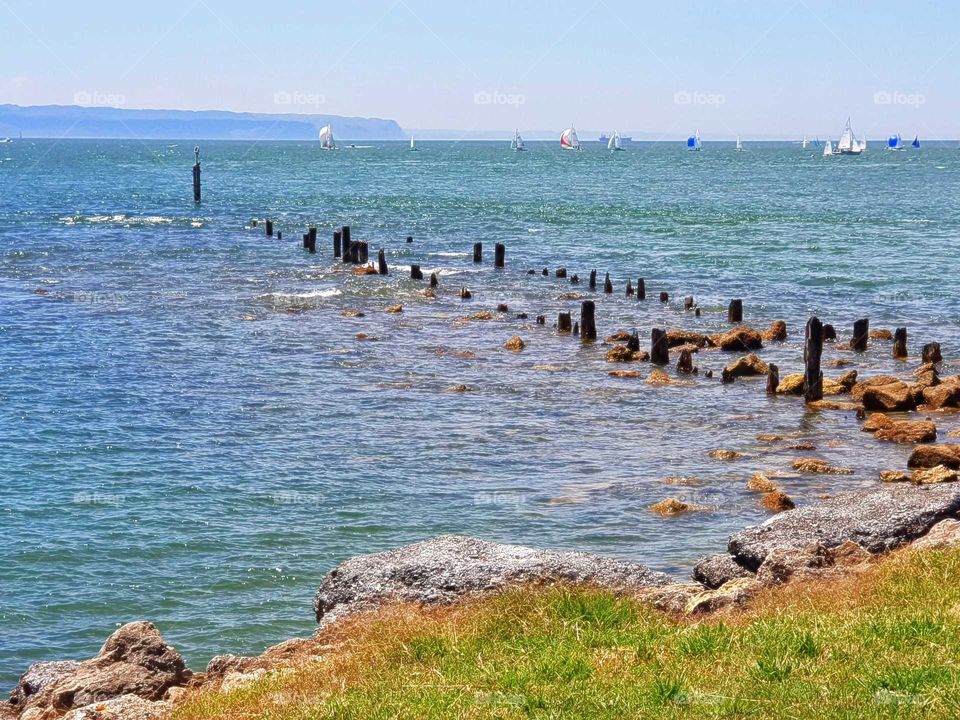 The skeleton of an old wooden jeti that once stood here. Over the years it has been reduced down to these jagged posts sticking out of the water they completely disappear on high tide.