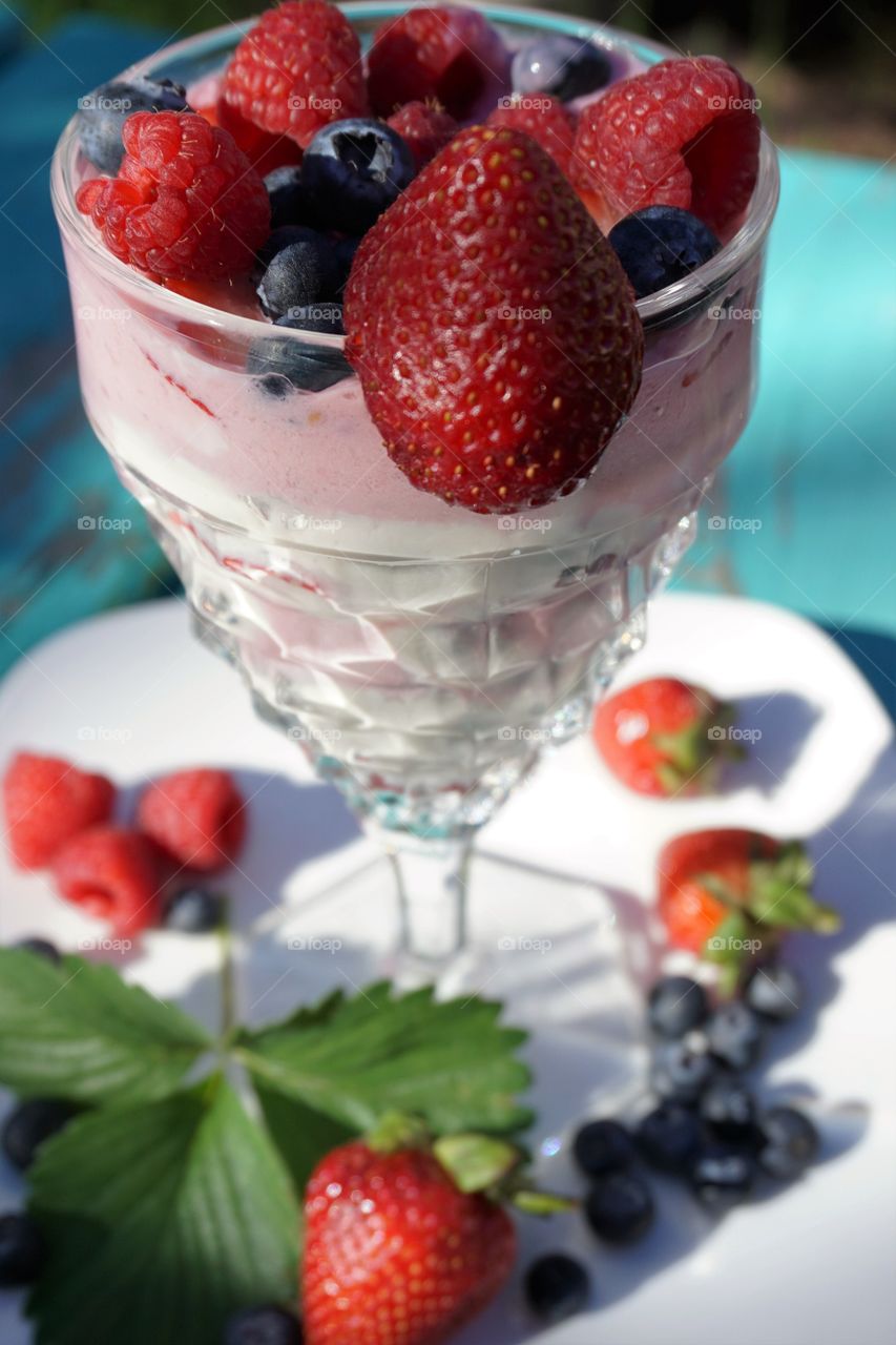 Delicious smoothie in glass on white plate