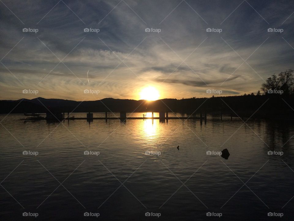 Reflection of sun on lake during sunset