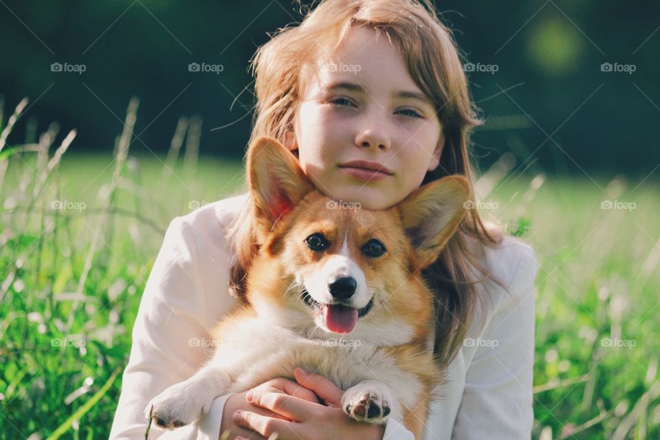 Girl with her dog on a field