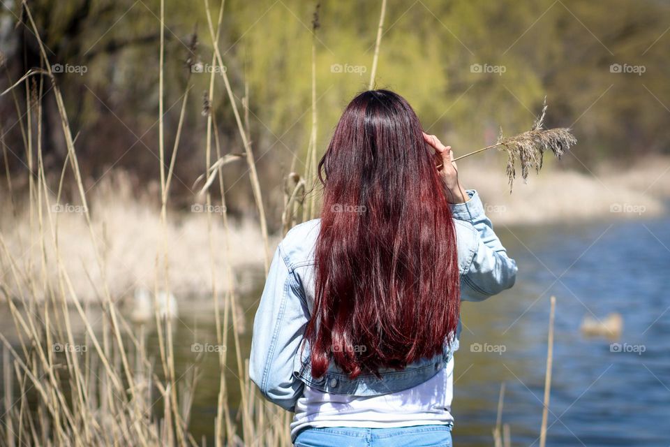 Woman with gorgeous red long hair  outdoors