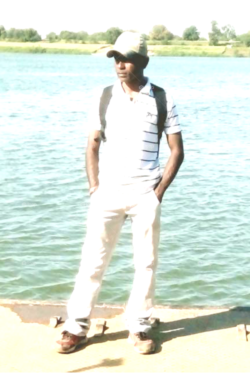 Photo of a man/photo of a man on a white t-shirt/photo in a light color dress/photo of a man model in new style/photo in rough and tuff style/photo of an Indian man/model photo in new style/Photos with water/style icon photo/modeling style icon photo