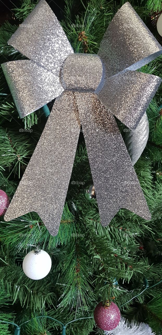 Big silver bow on our Christmas tree this year looks beautiful and sparkly