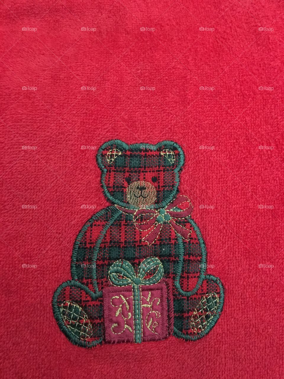 Appliqué teddy bear on red