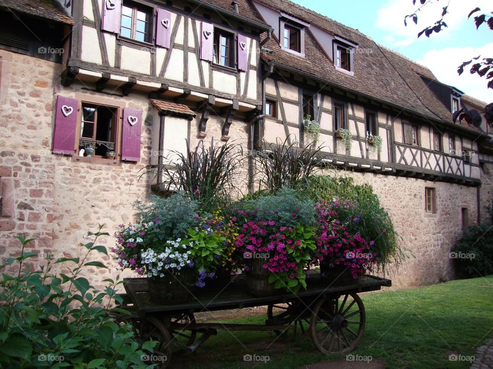 Beautiful floral display in a medieval village ... very pretty cart laden with flowers 