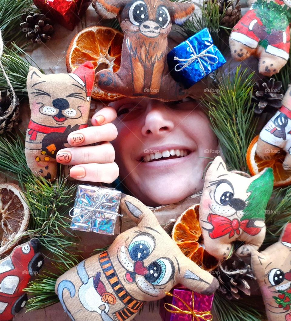 Original photo of a girl with handmade children's toys painted with paints