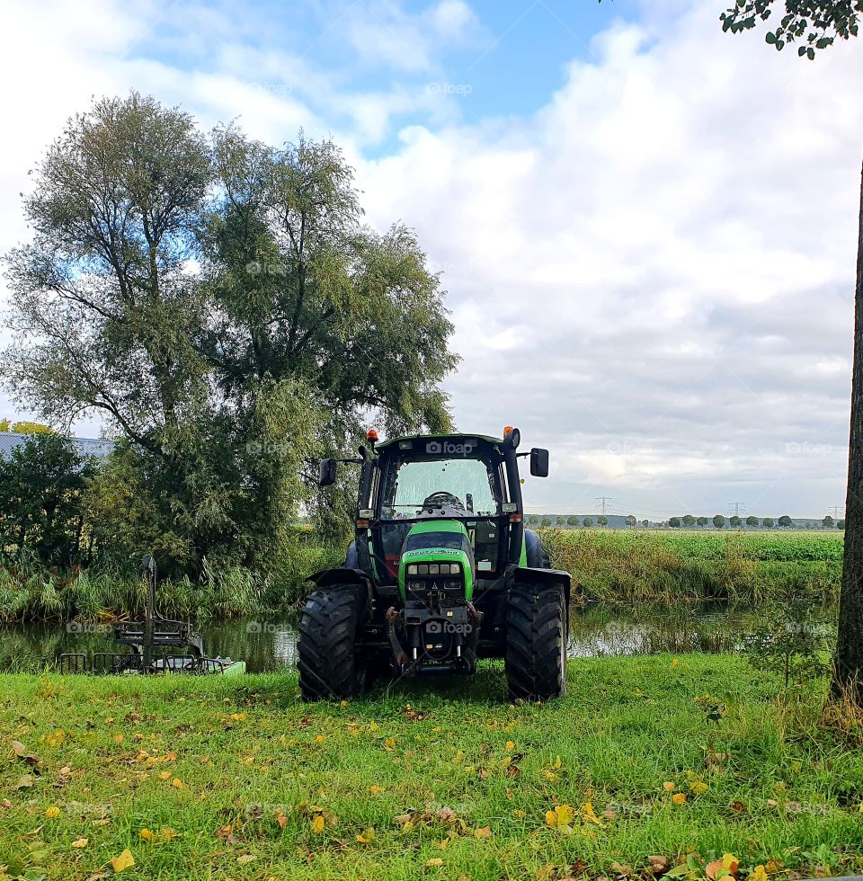 Tractor stationary along the road.