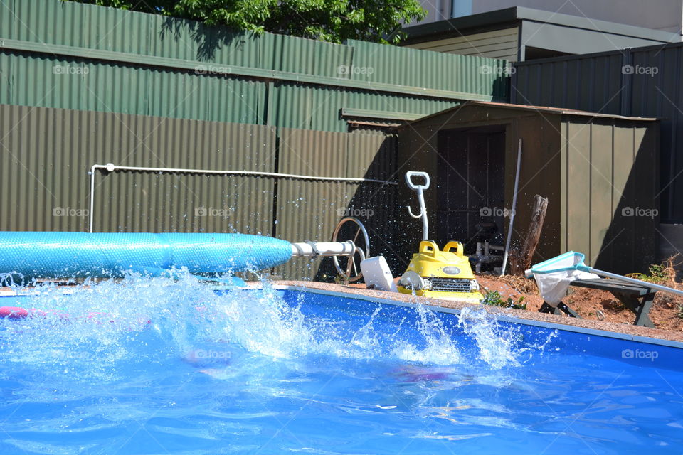 Water splash in swimming pool outdoors 