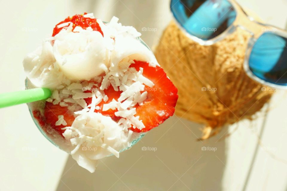 Fresh Fruit smoothie - Young Coconut smoothie topped with slices of strawberries and diced coconut meat
