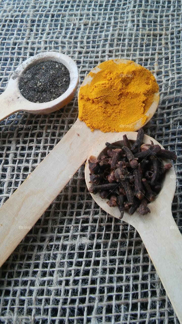spice herb cloves pepper turmeric closeup spoons wood health cooking burlap. country cuisine