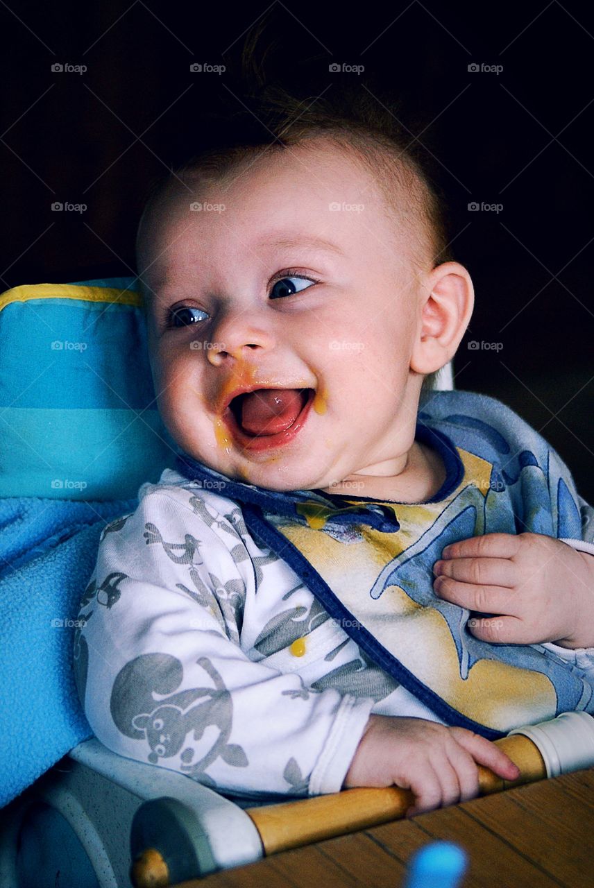 Smiling child with food around his face