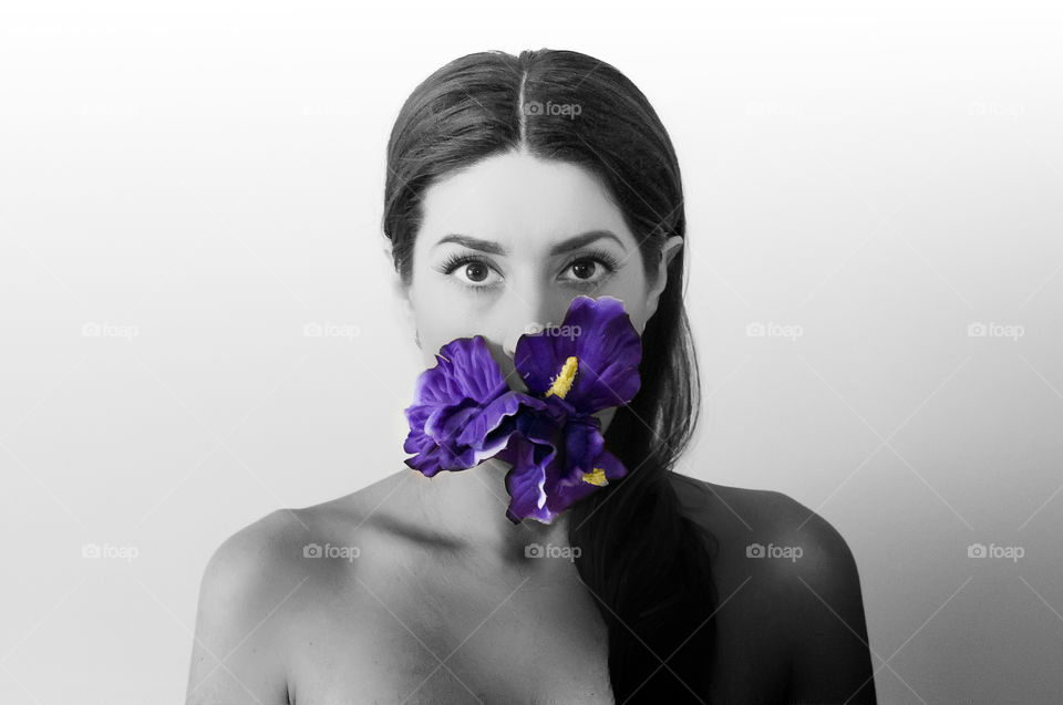 Portrait of woman holding purple flower