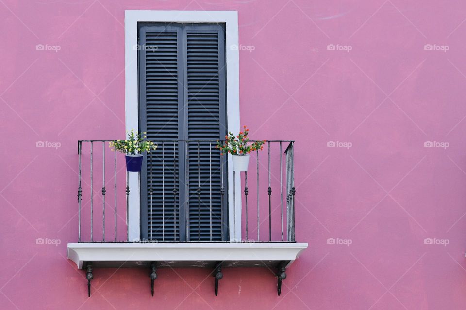 Balcony on a pink wall